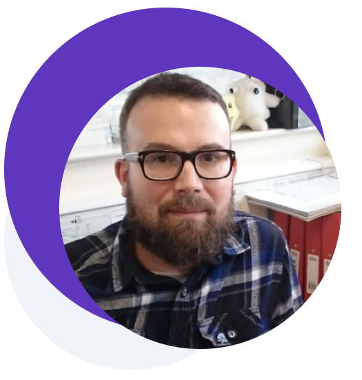 Picture of a bearded man with glasses and checked shirt