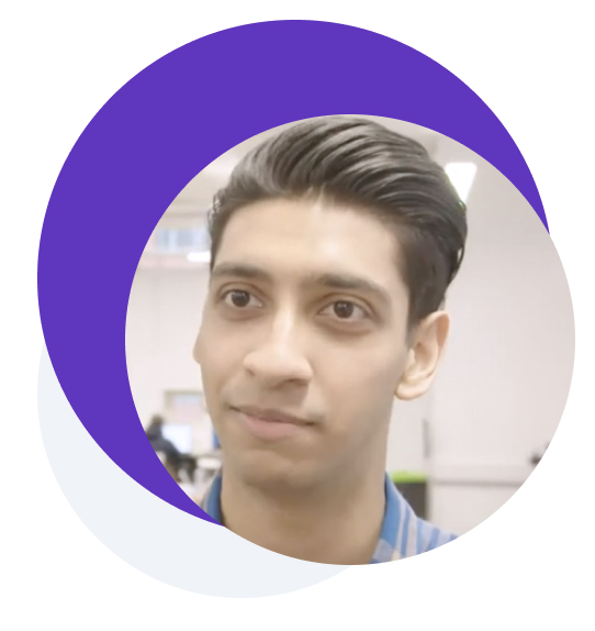 Picture of a man with a slight smile in a classroom