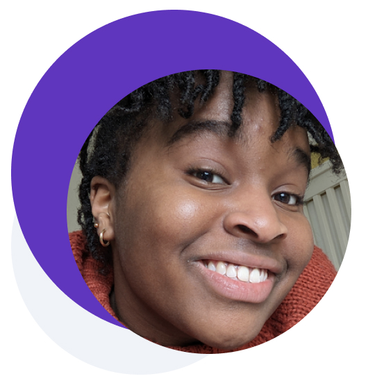 Picture of a smiling woman with bangs and earrings
